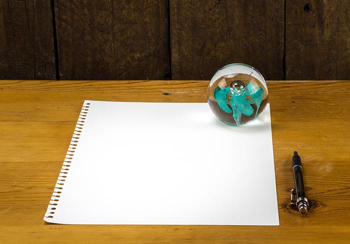 Paper and pen with ball paperweight