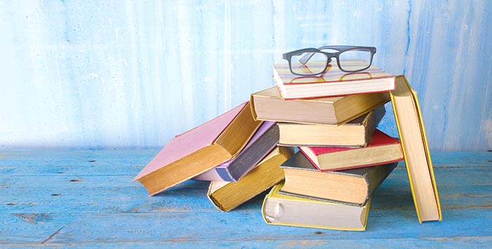 Pile of books with glasses